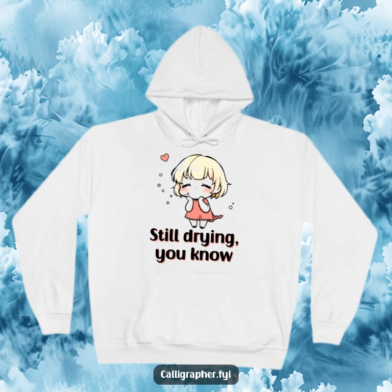 Funny Hoodie: A cute character gently blows on a newly inked design, highlighting the careful process of artistic creation.